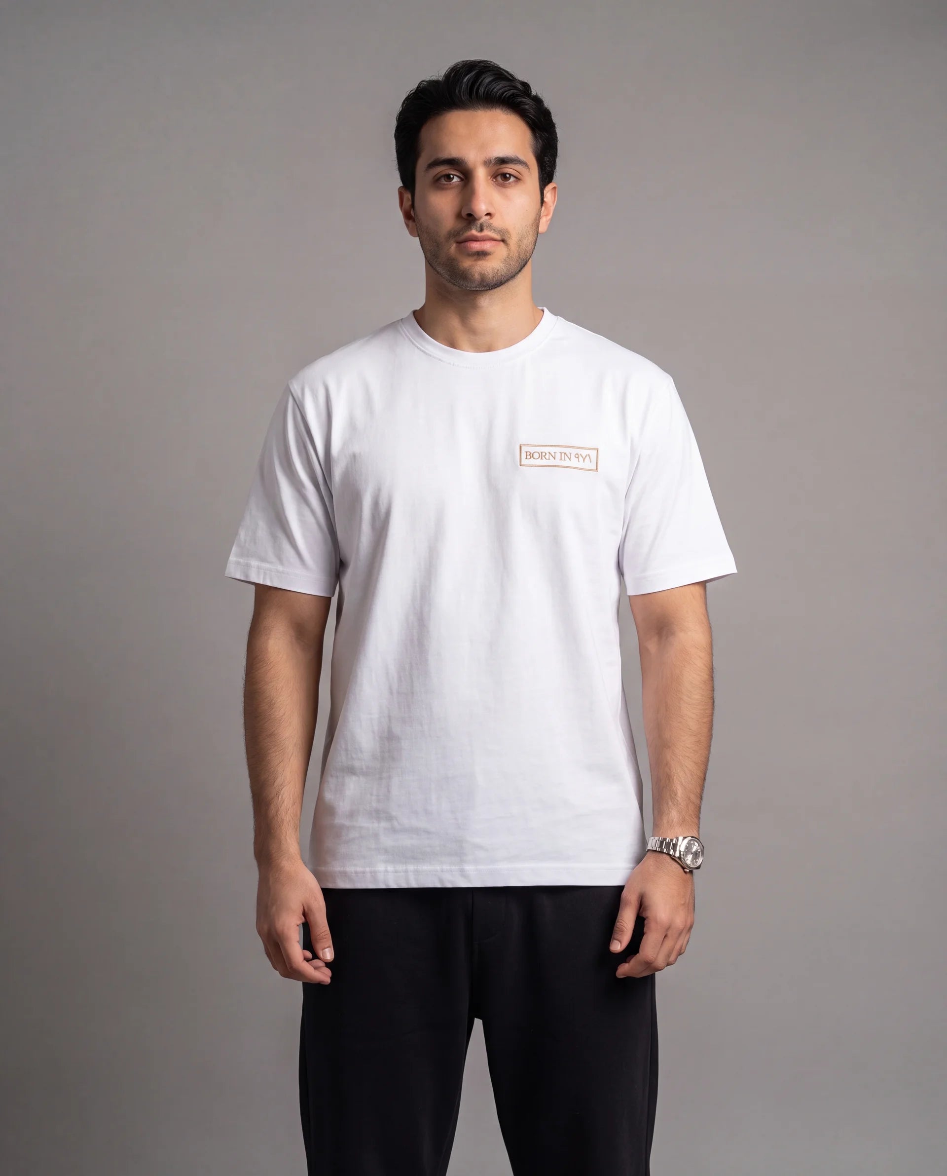 The Ghaf Tee in white, front view on model